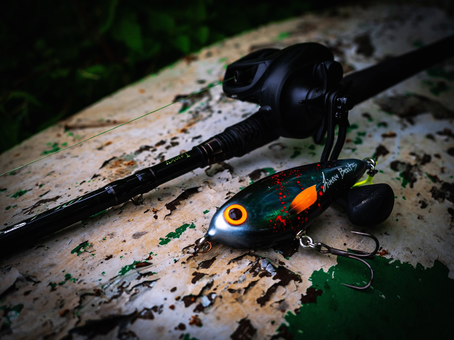 Handmade perch-pattern jerkbait on workshop bench